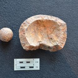 A piece of grape shot (left) and an exploded mortar bomb (right) recovered during scientific excavation at the Lake George Battlefield Park